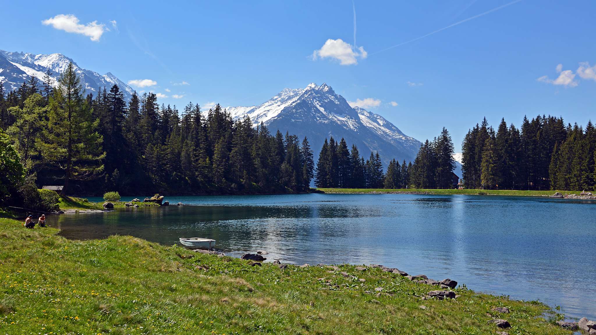 Blick vom Ufer des Arnisees auf die hohen Berge im Hintergrund