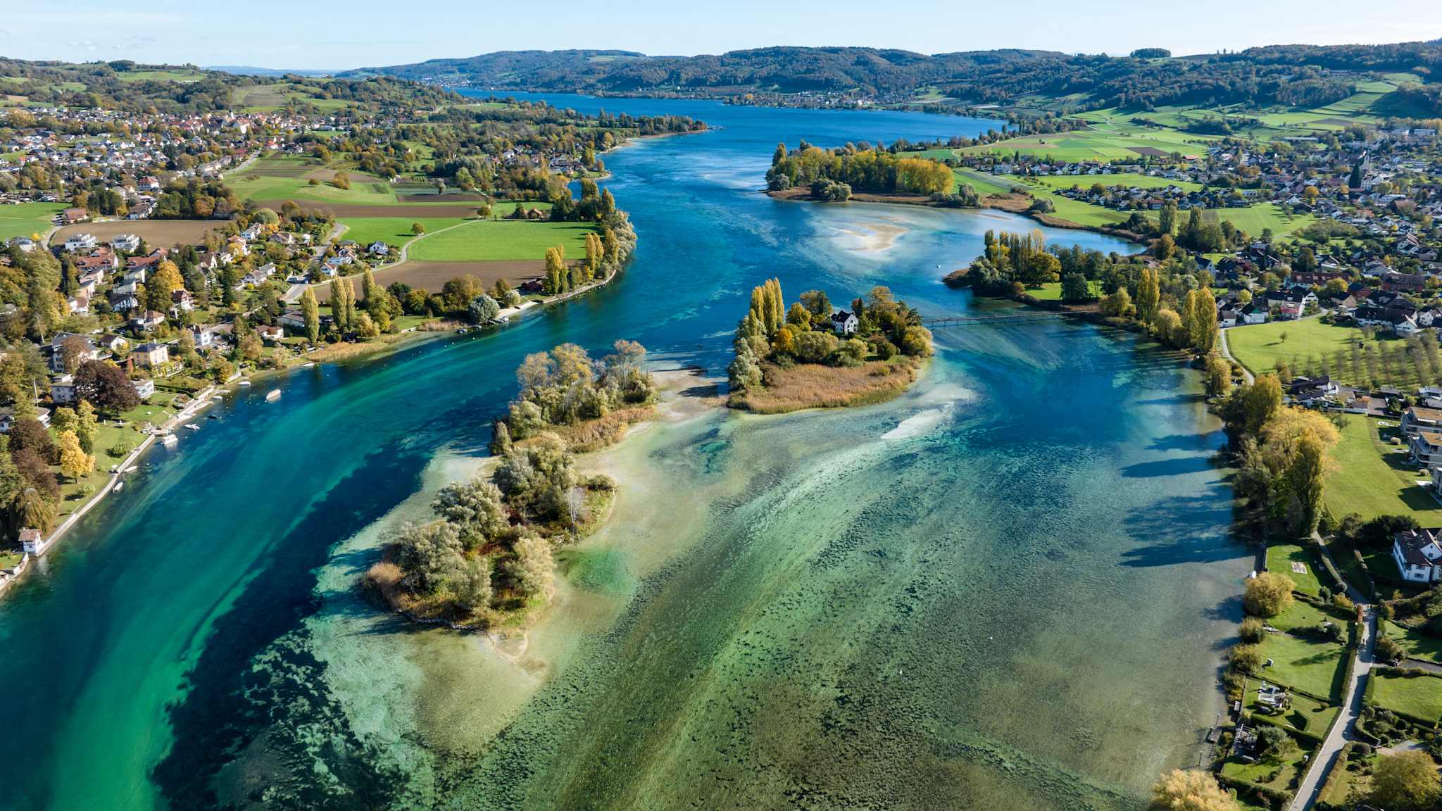 Blick von oben auf eine kleine Inselgruppe zwischen zwei Ortschaften