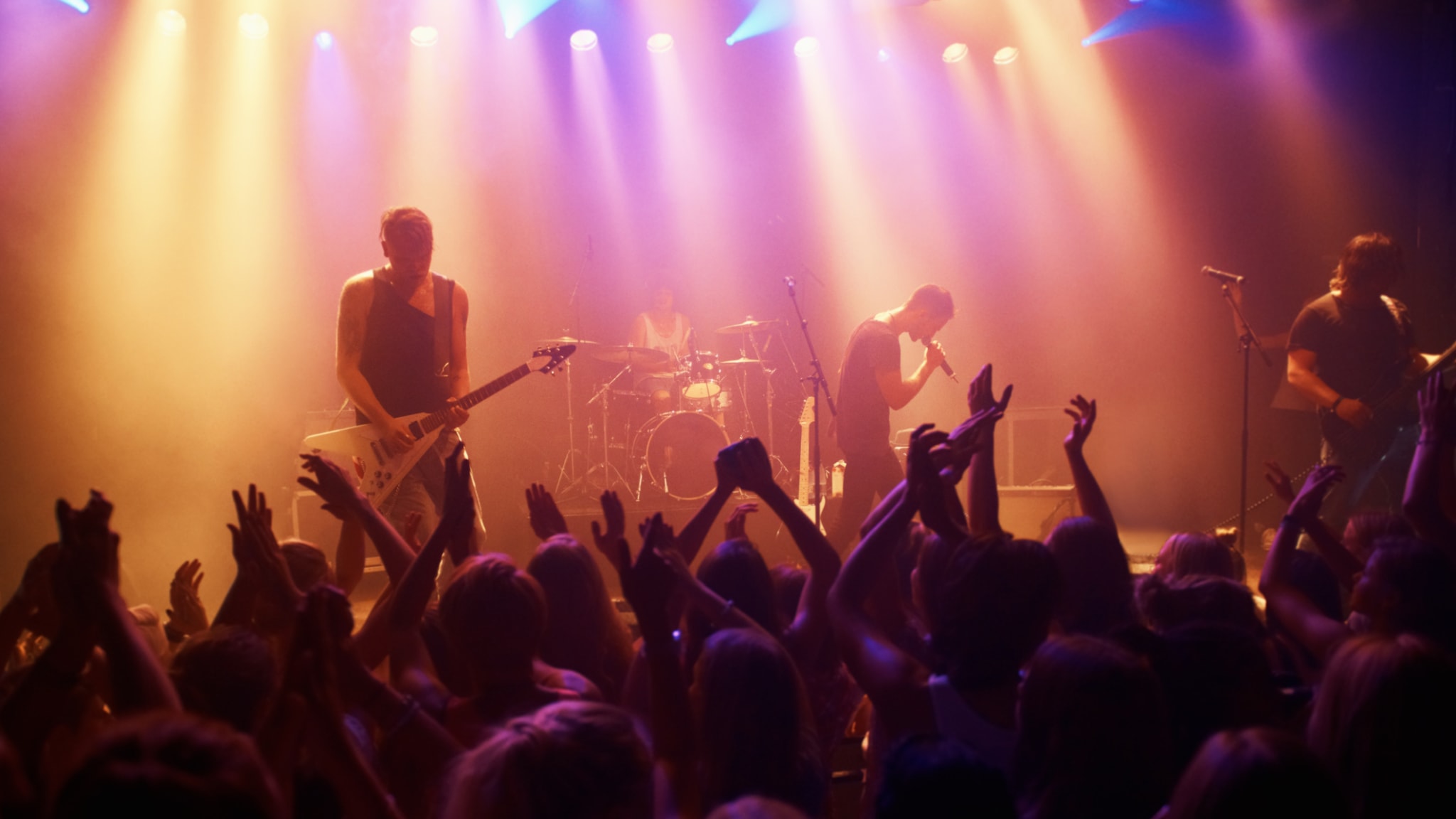 Menschen feiern bei einem Rockkonzert © PeopleImages/iStock / Getty Images Plus via Getty Images