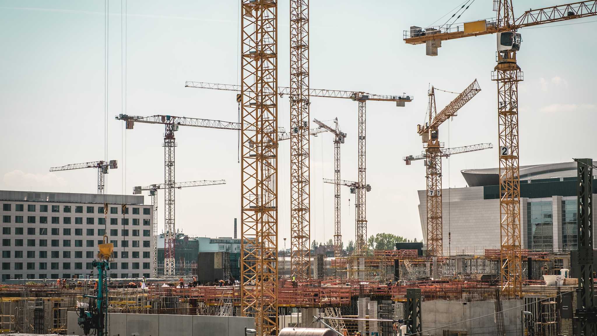 Zahlreiche Baukräne in einer Stadt.