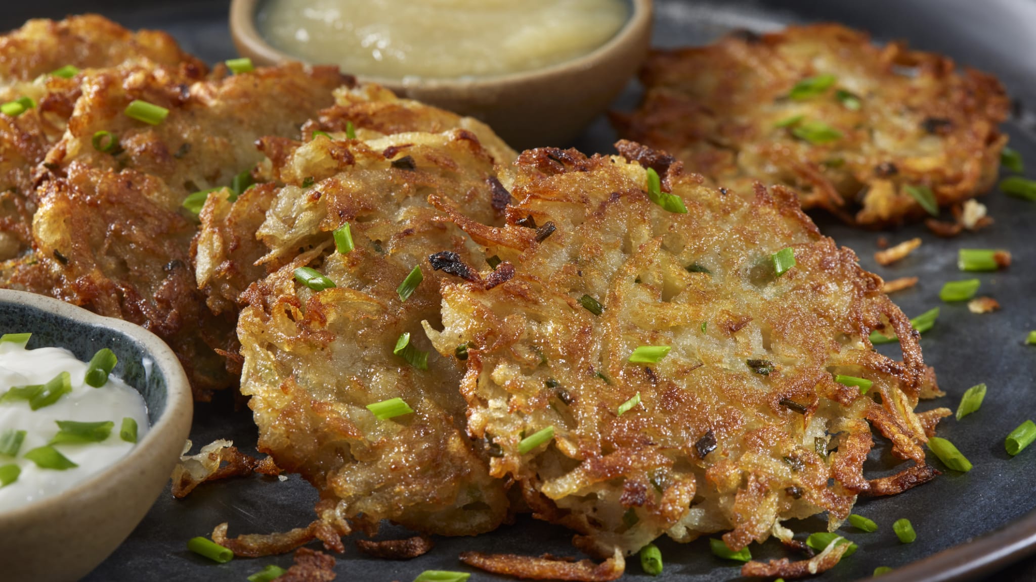 Ein Teller mit Kartoffelrösti und zwei Dips. © LauriPatterson/E+ via Getty Images
