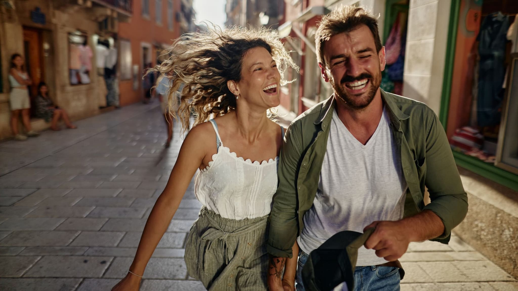 Ein Pärchen läuft lachend durch die Stadt.