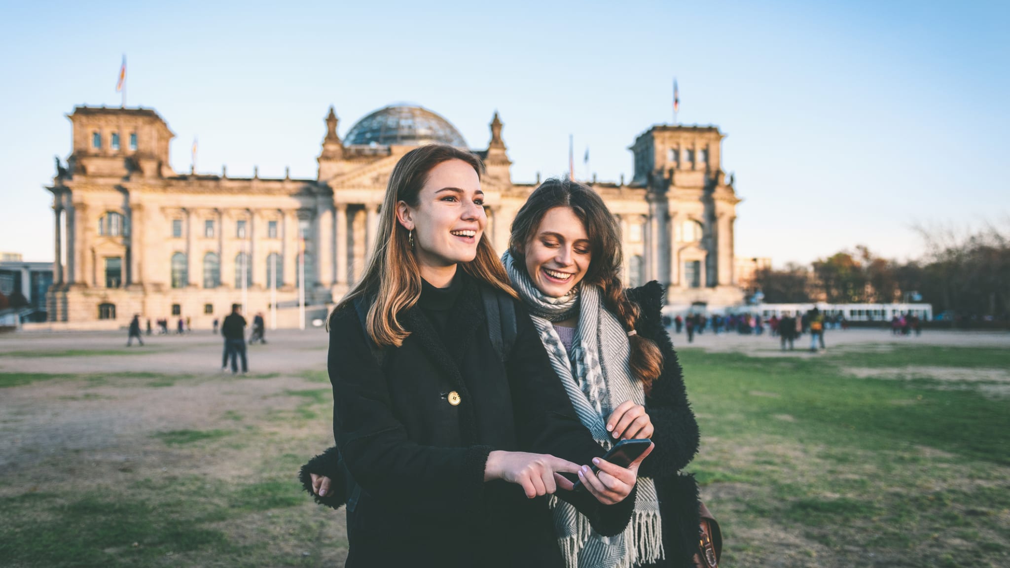 Zwei Frauen stehen vor dem Reichstag in Berlin.