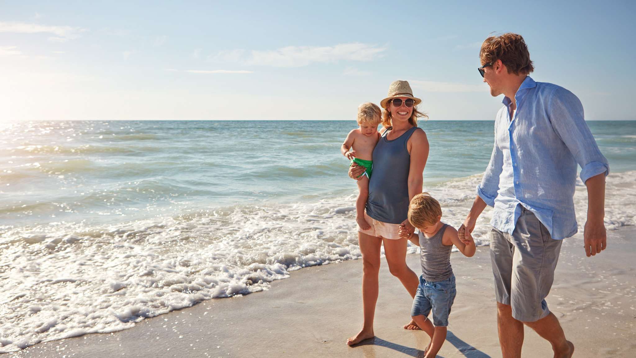 Vater, Mutter mit zwei Kindern am Strand