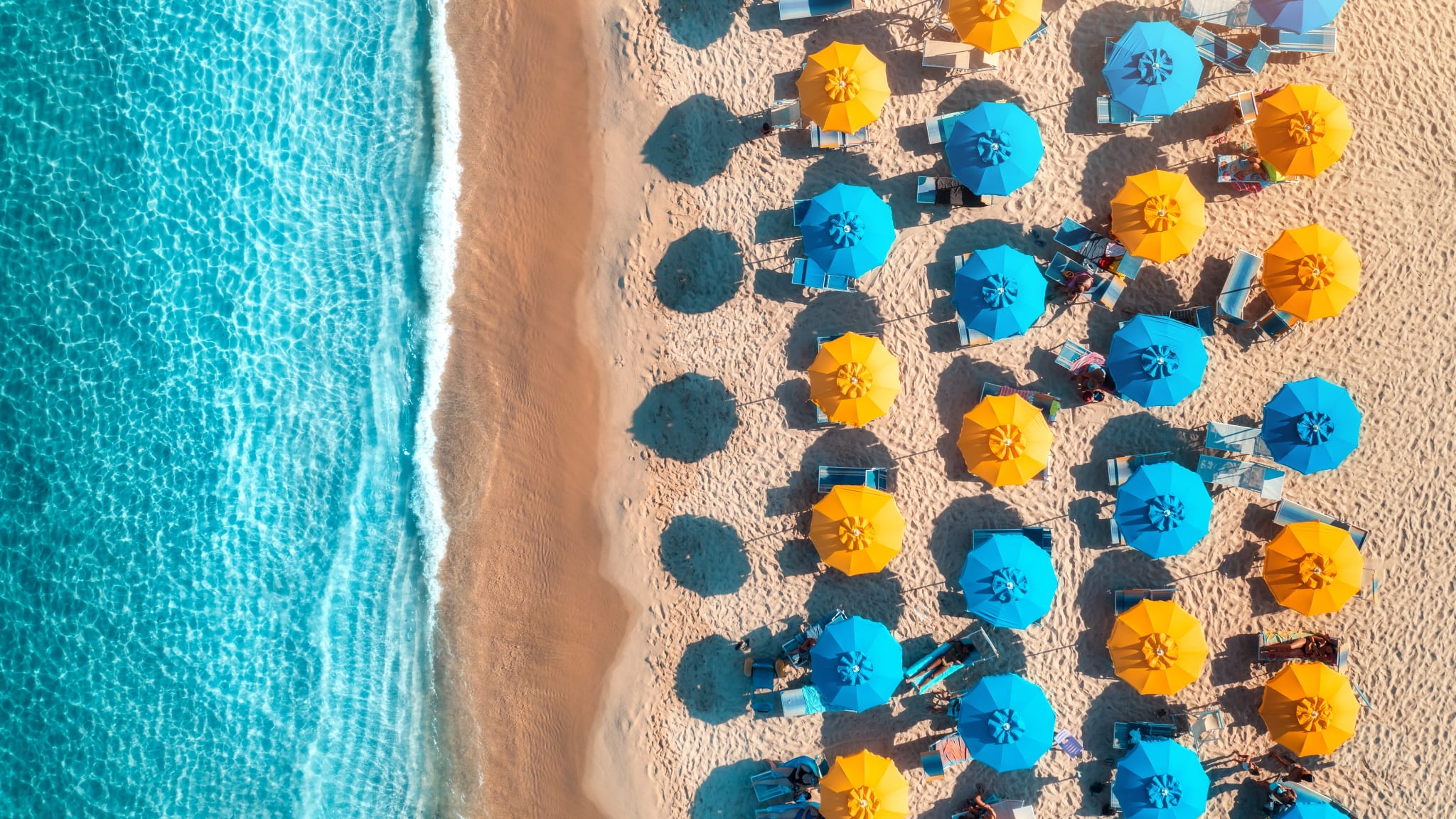 Meer, Strand und bunte Sonnenschirme