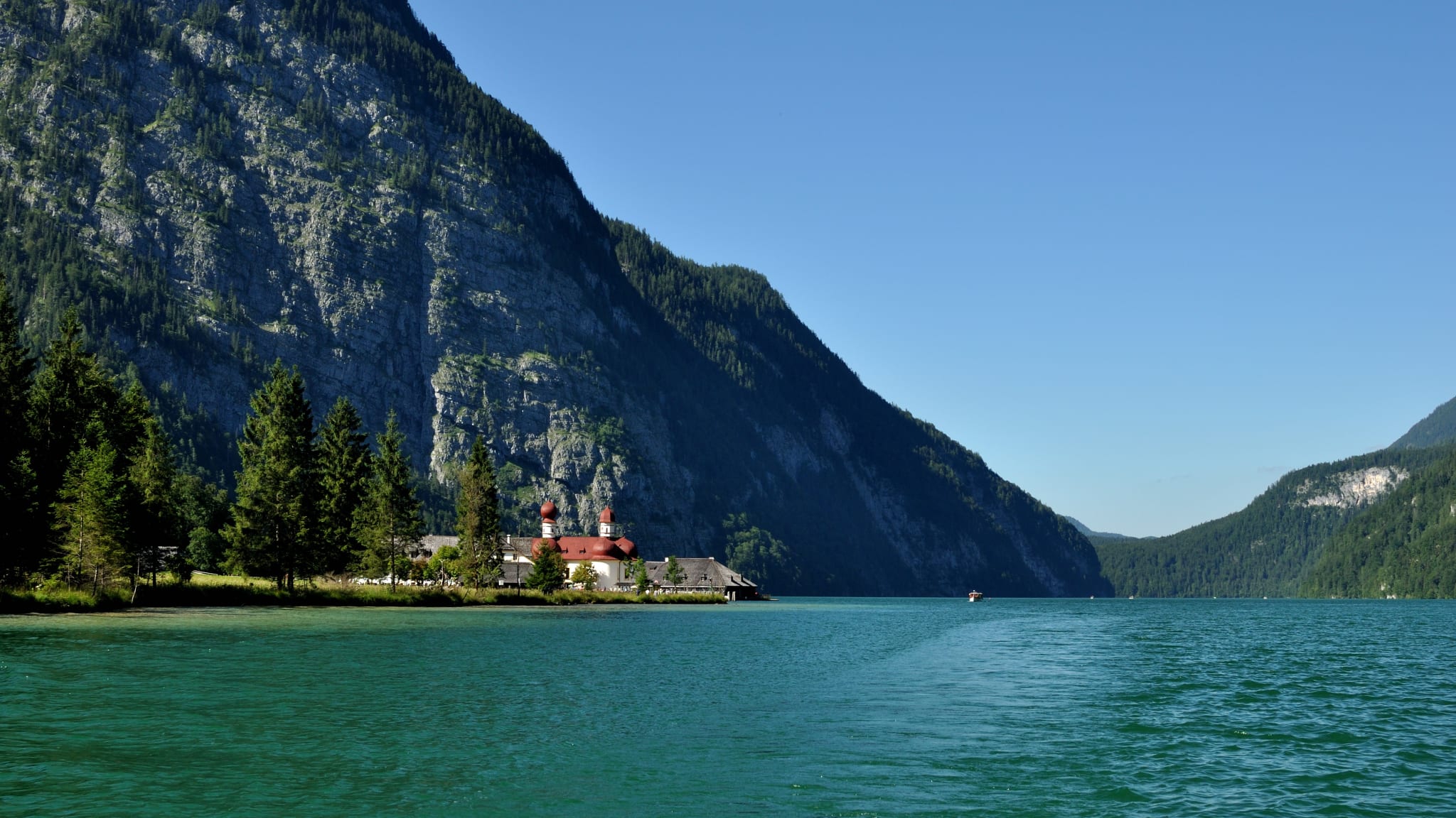 Scenic View Of Sea And Mountains Against Clear Blue Sky
