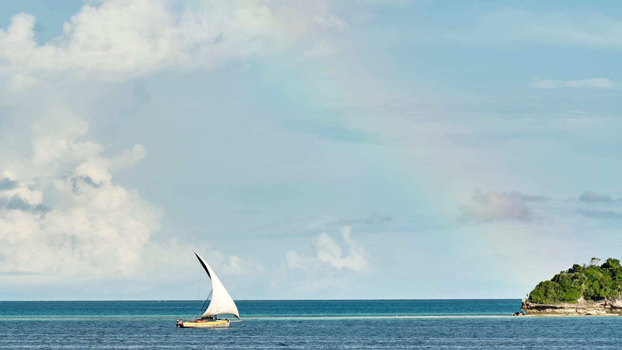 Yacht in sea under rainbow, Zanzibar City, Zanzibar Urban, Tanzania, Africa
