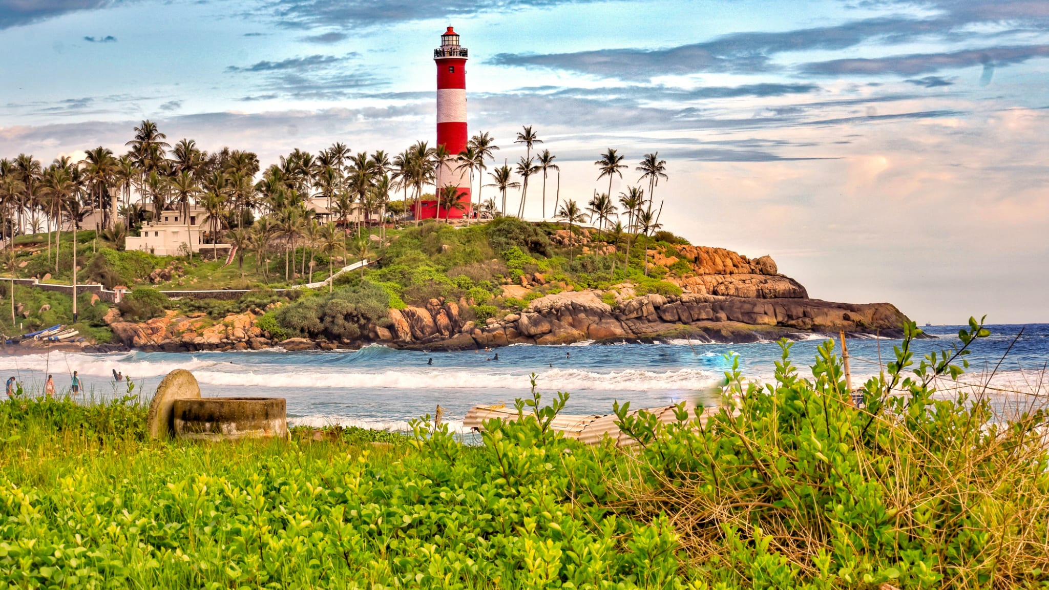 Lighthouse On Beach By Sea Against Sky