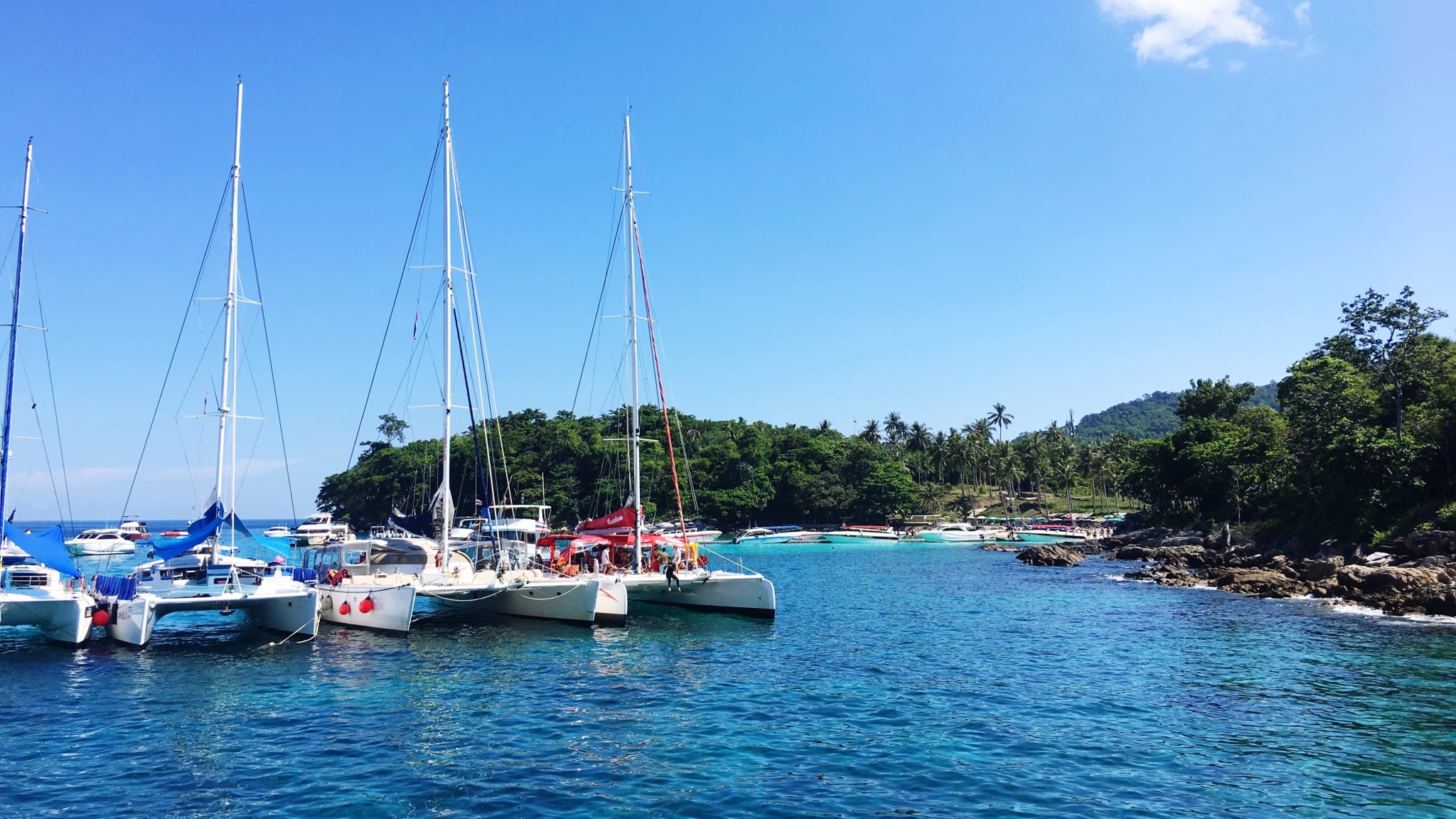 Boats Moored In Sea Against Clear Blue Sky