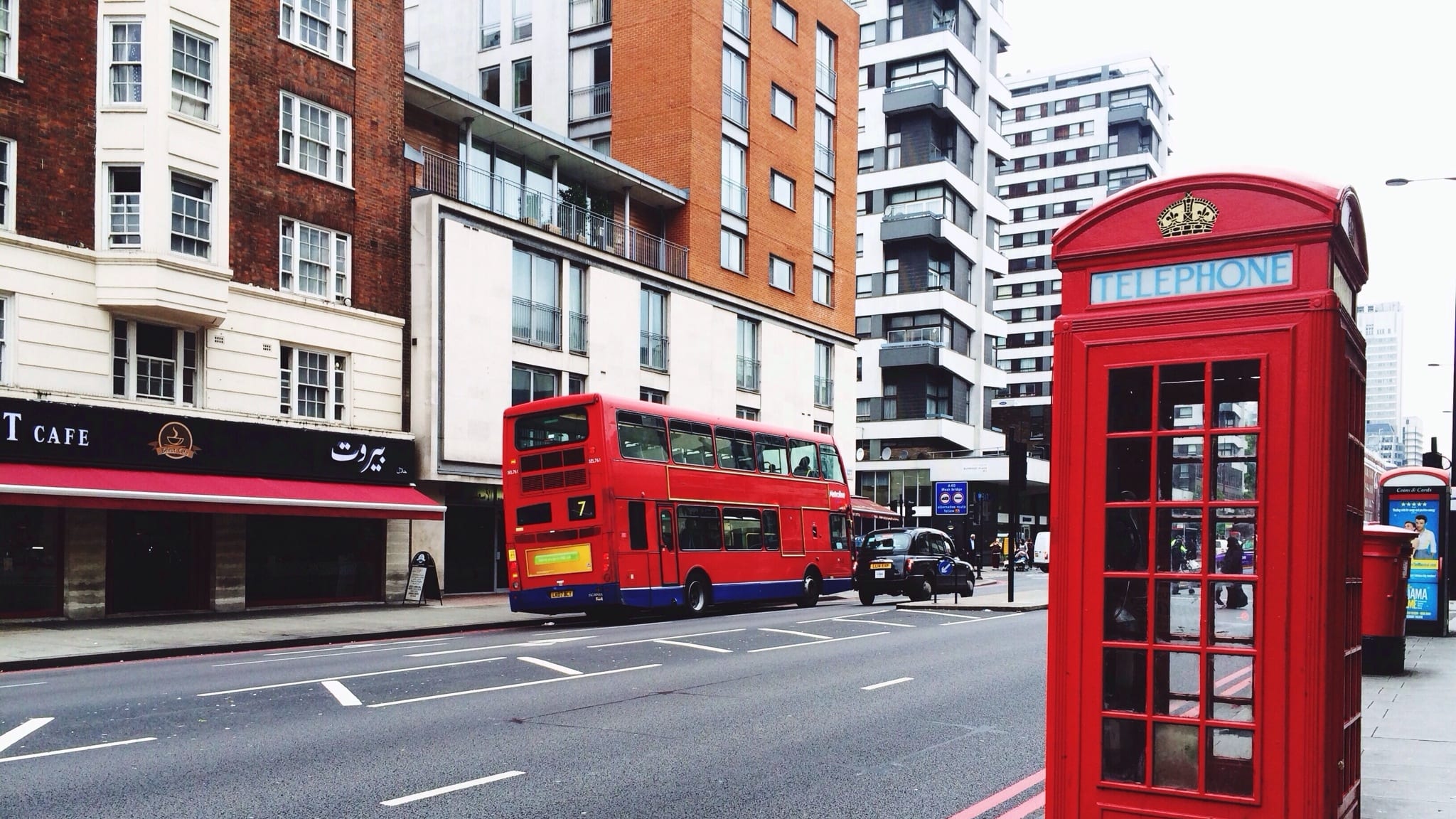 Telephone Booth On Sidewalk By City Street