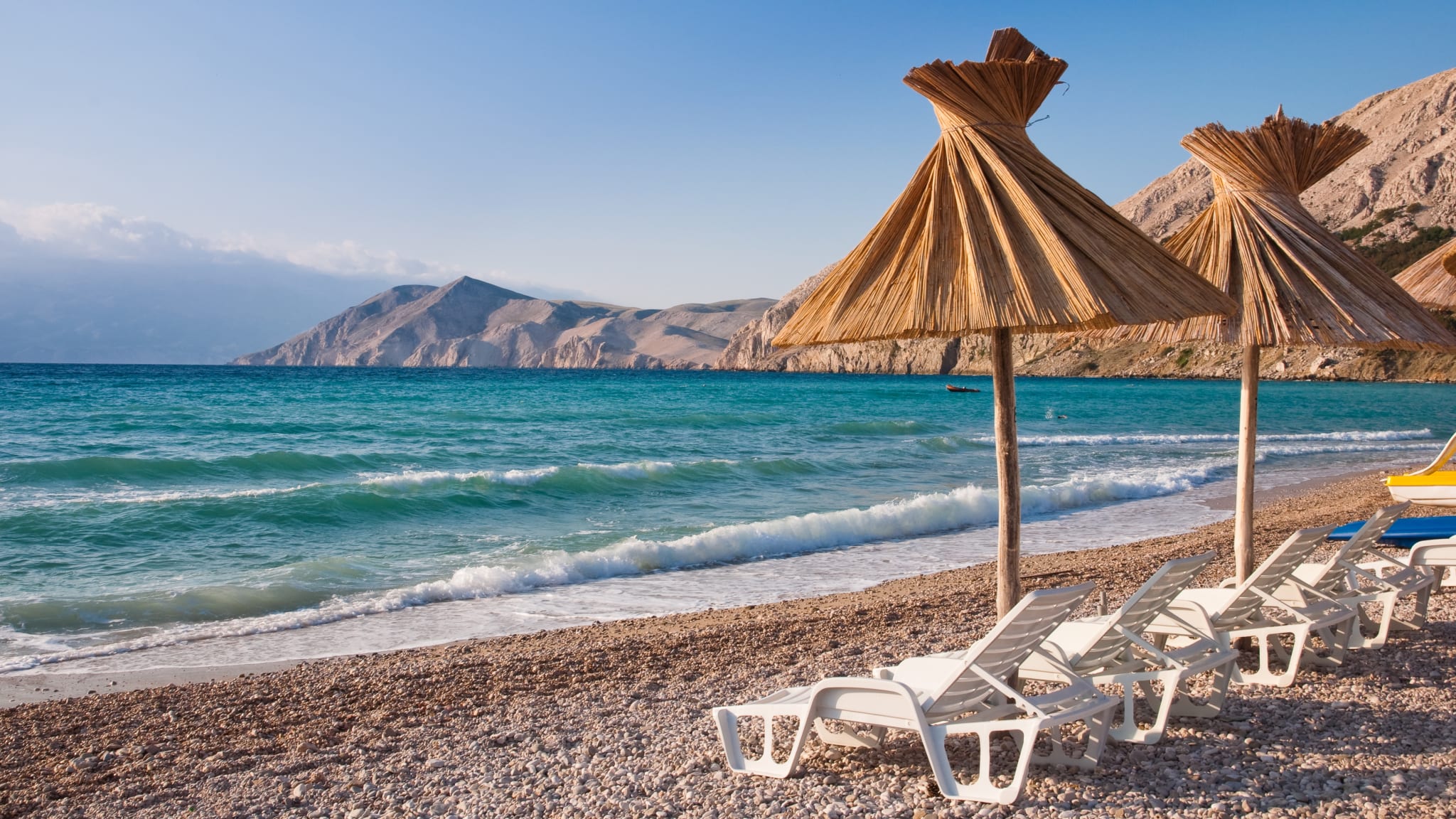 Sunshade and deck chair on beach at Baska in Krk - Croatia