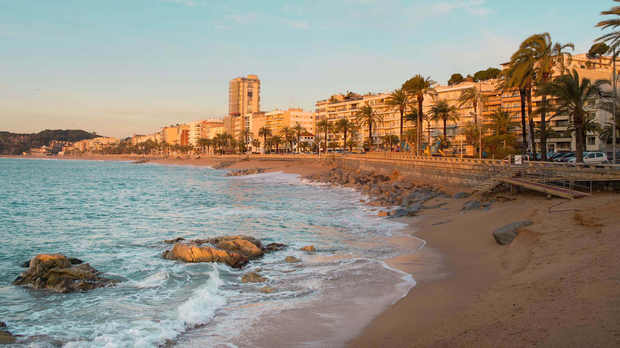 Spain, Costa Brava, Lloret de Mar, view to beach promenade at sunrise