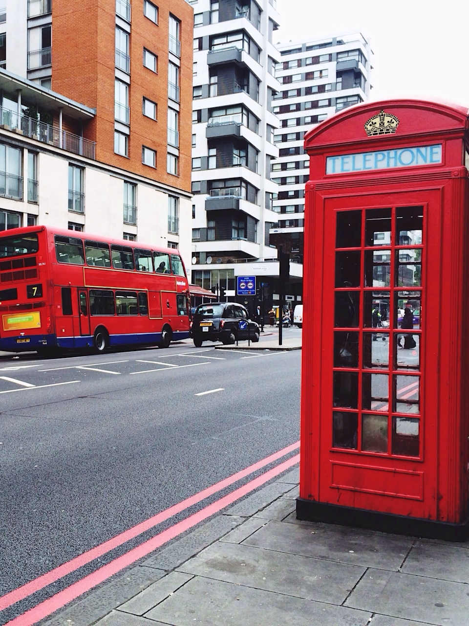 Telephone Booth On Sidewalk By City Street