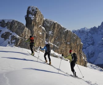 Gruppe von Personen läuft Ski in den Dolomiten © iStock.com/Gorfer