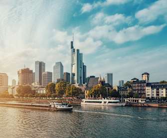 City At Waterfront Against Cloudy Sky