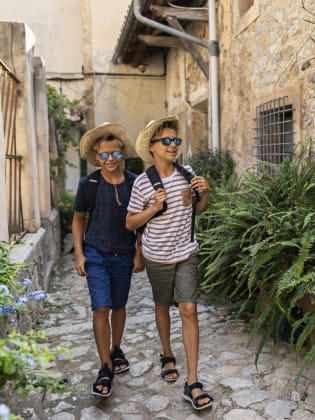 Teenager spazieren durch die engen Gassen der Stadt Valldemosa © iStock.com/Imgorthand