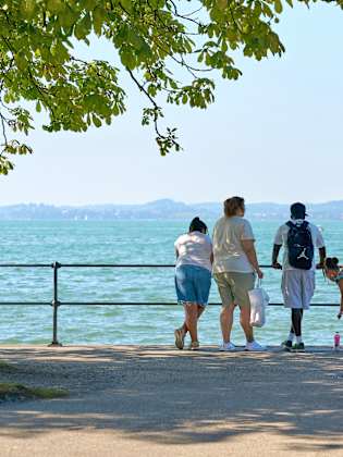 Familie steht am Ufer der Bodensees