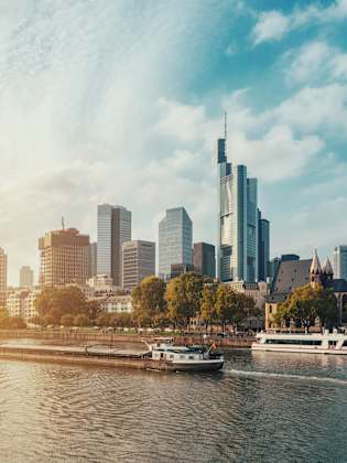 City At Waterfront Against Cloudy Sky