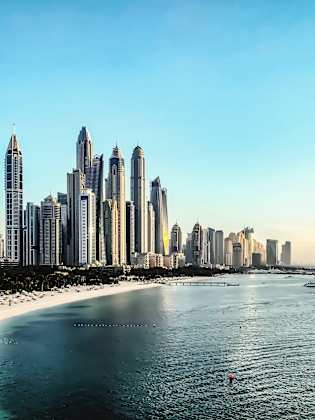 View Of City At Waterfront Against Sky