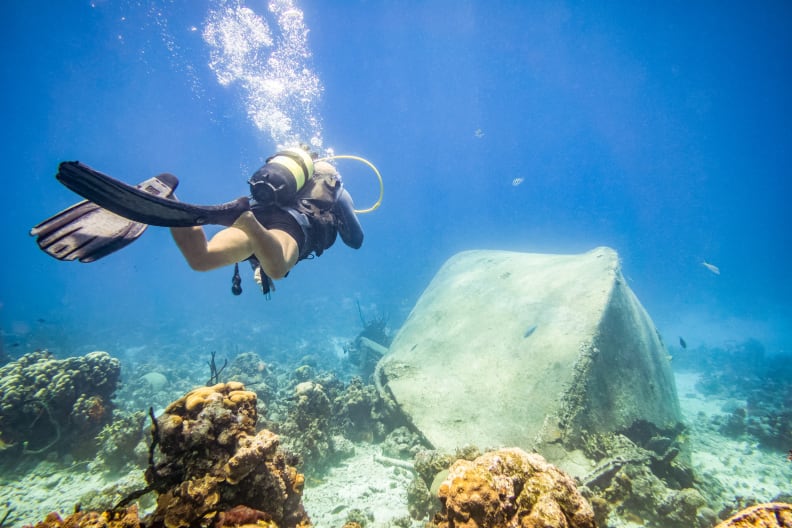 Taucher bei der Erkundung eines überwucherten Schiffswracks in Playa Larga, Kuba © iStock.com/Eloi_Omella