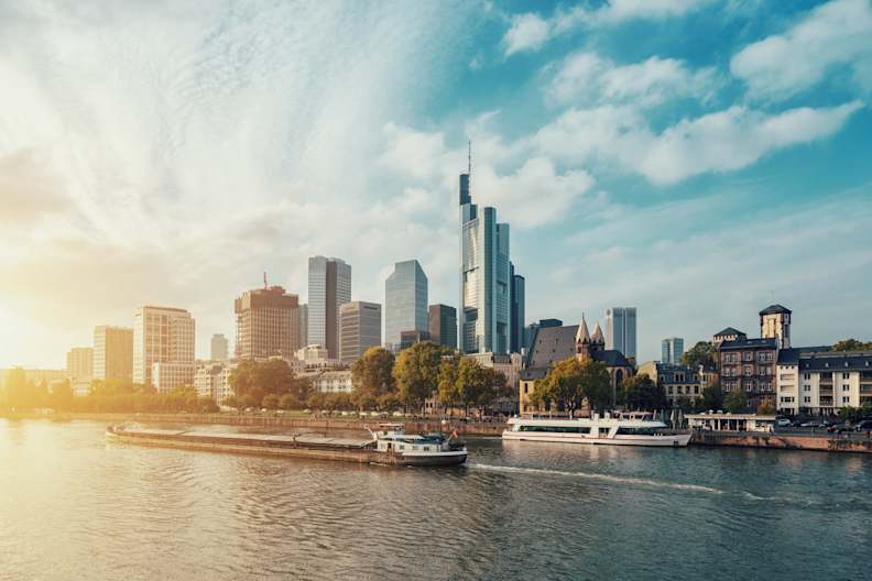 City At Waterfront Against Cloudy Sky