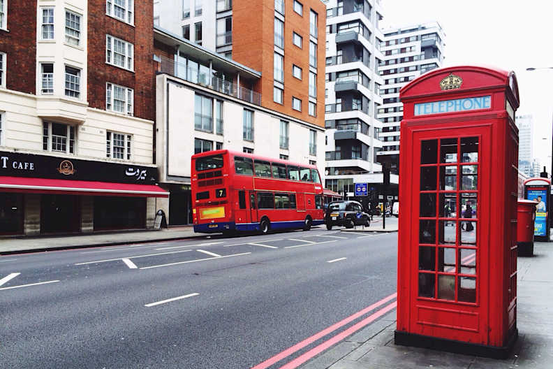Telephone Booth On Sidewalk By City Street