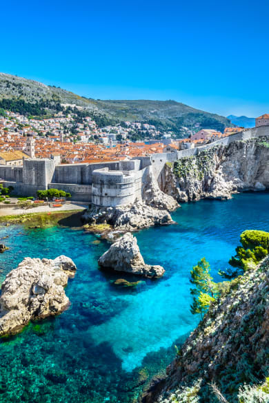 Blick auf die Stadt Dubrovnik mit ihrer Stadtmauer auf der Felsküste © iStock.com/Dreamer4787