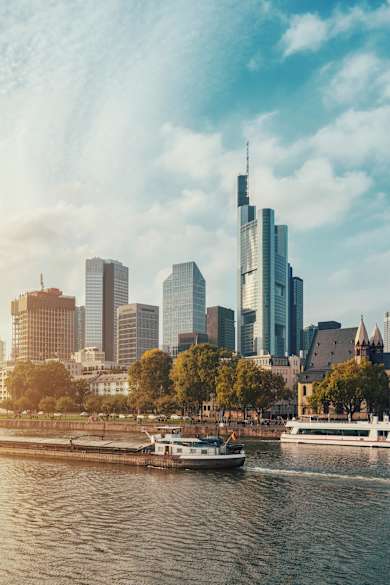 City At Waterfront Against Cloudy Sky