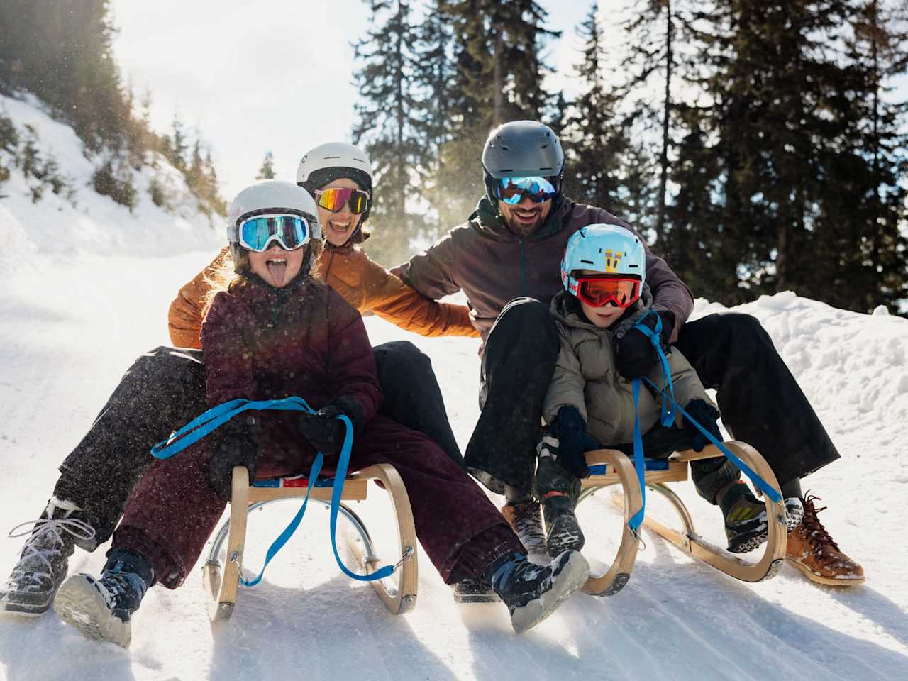 Bild von Familie auf Schlitten.