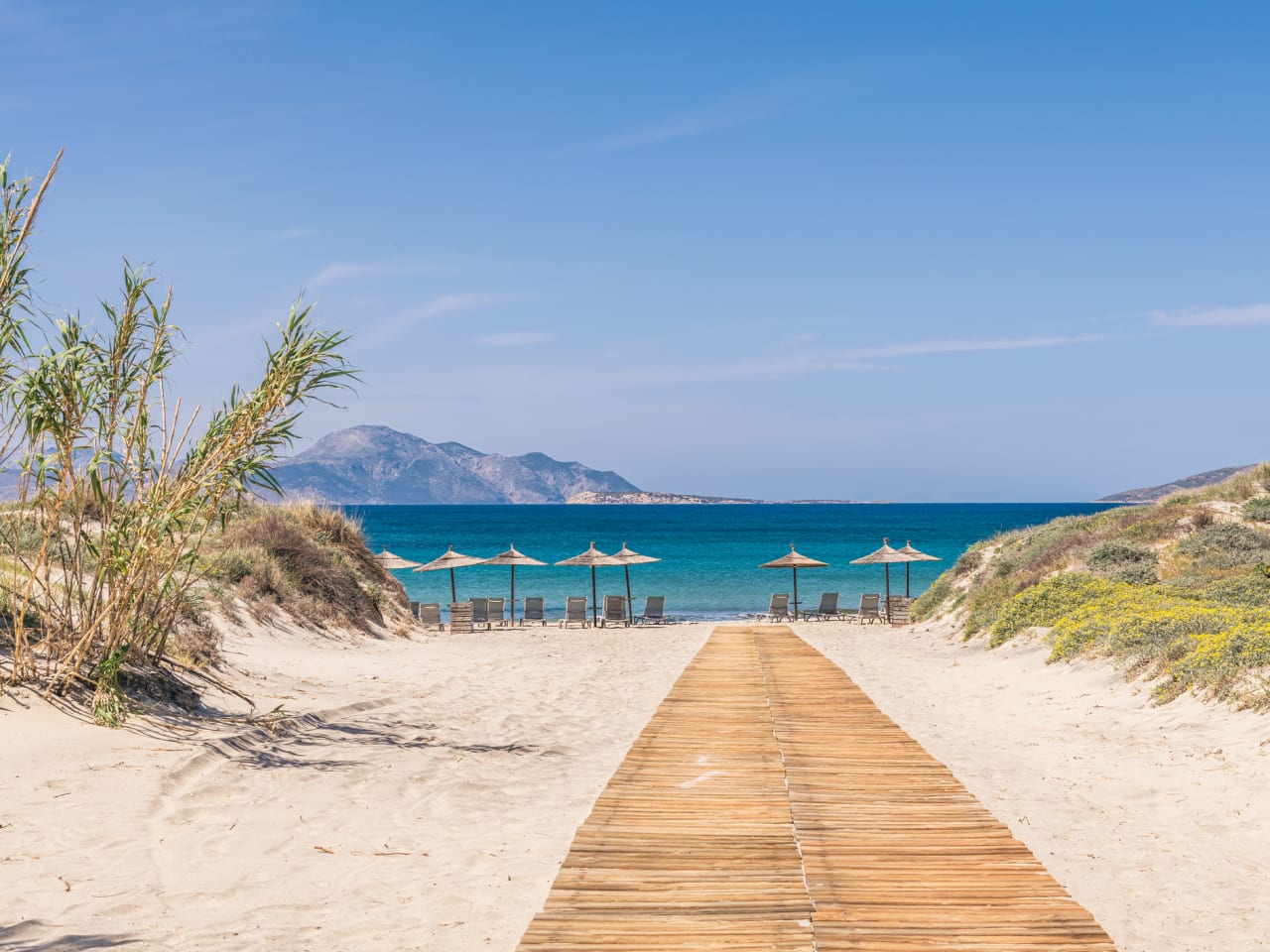 Ein Holzweg zu einem Strand auf Kos, Griechenland. © George Papapostolou photographer/Moment via Getty Images