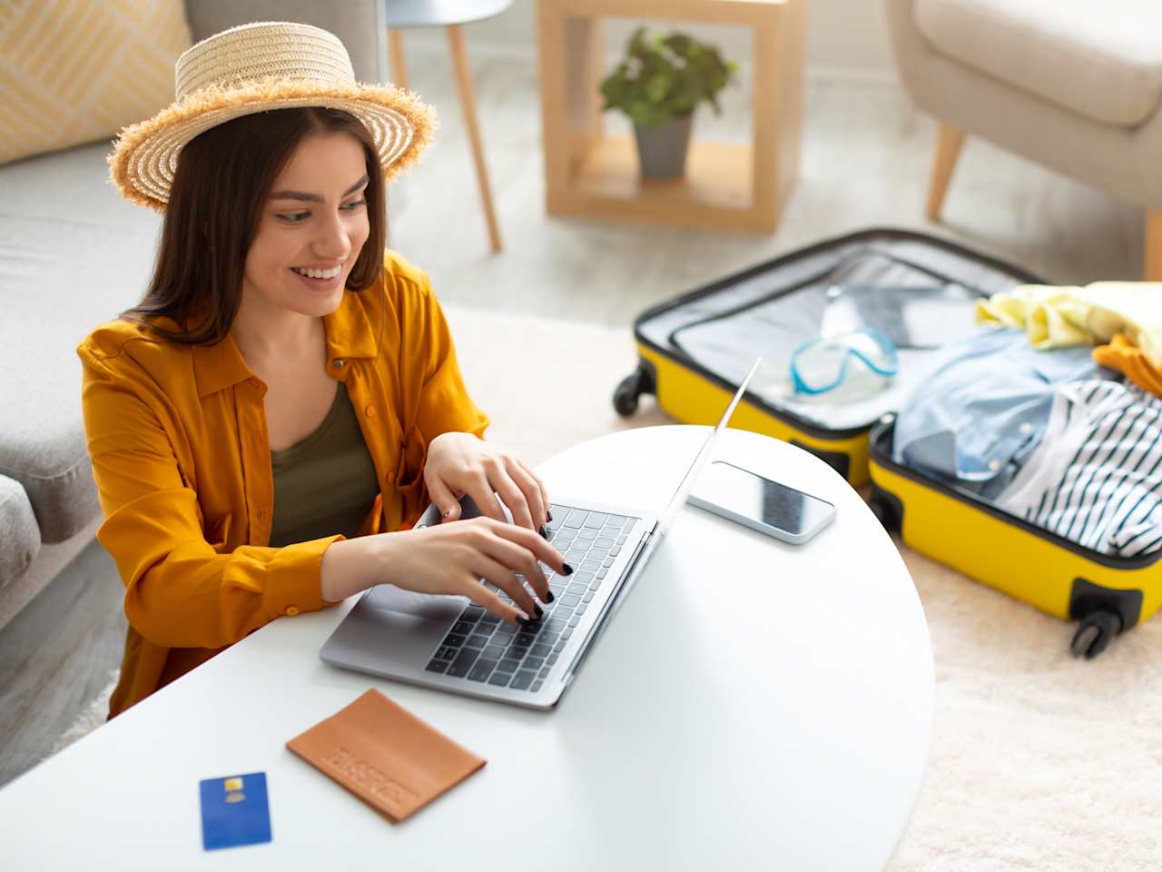 Frau bucht ihren Urlaub online am Laptop
