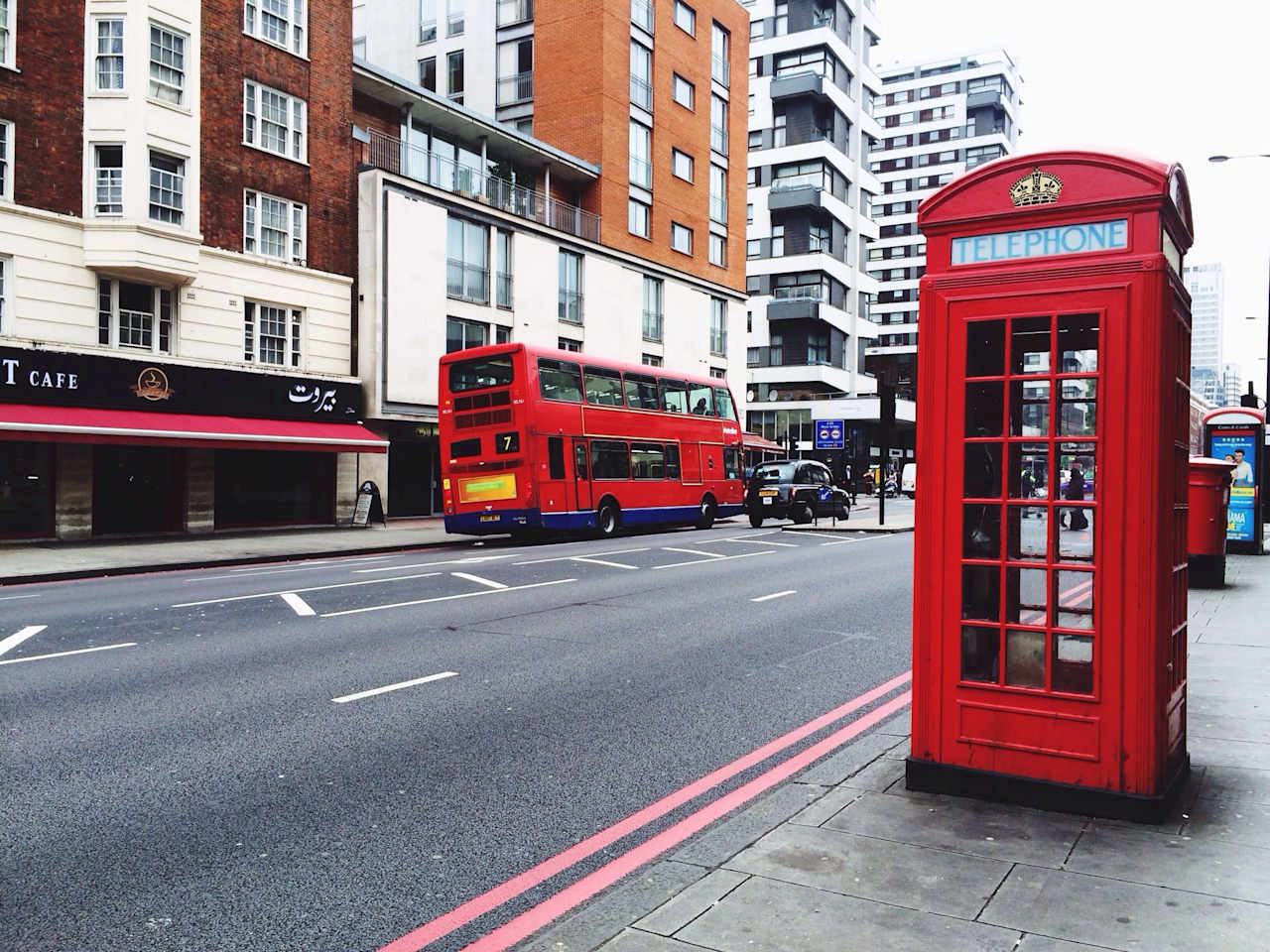 Telephone Booth On Sidewalk By City Street