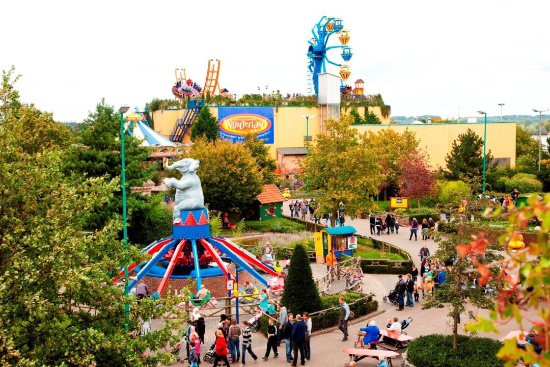 Aerial view of a family-friendly amusement park with colorful rides, illustrating the importance of staying alert during severe weather in Wisconsin