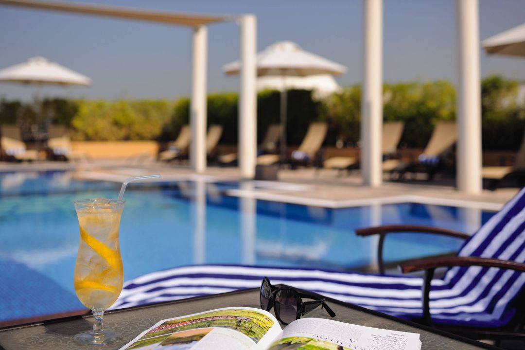 "Relaxation by the pool" Mövenpick Hotel Apartments Al Mamzar Dubai