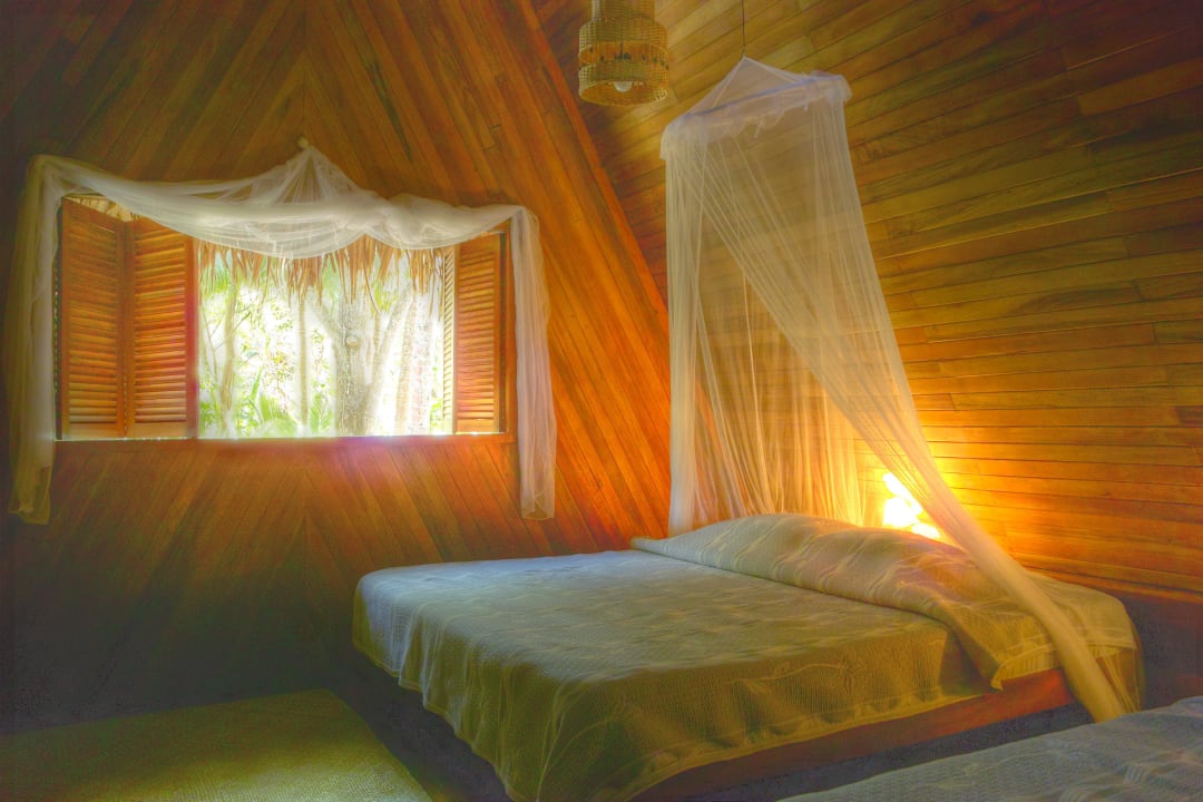 Slaapkamer in de bungalows Calala Beach Lodge