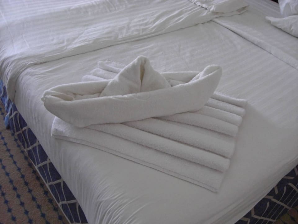 Полотенце на кровати. Полотенца на кровати в гостинице. Фигуры из полотенца в отеле. Красиво сложенные полотенца в гостинице. Красиво сложить полотенце в отеле.