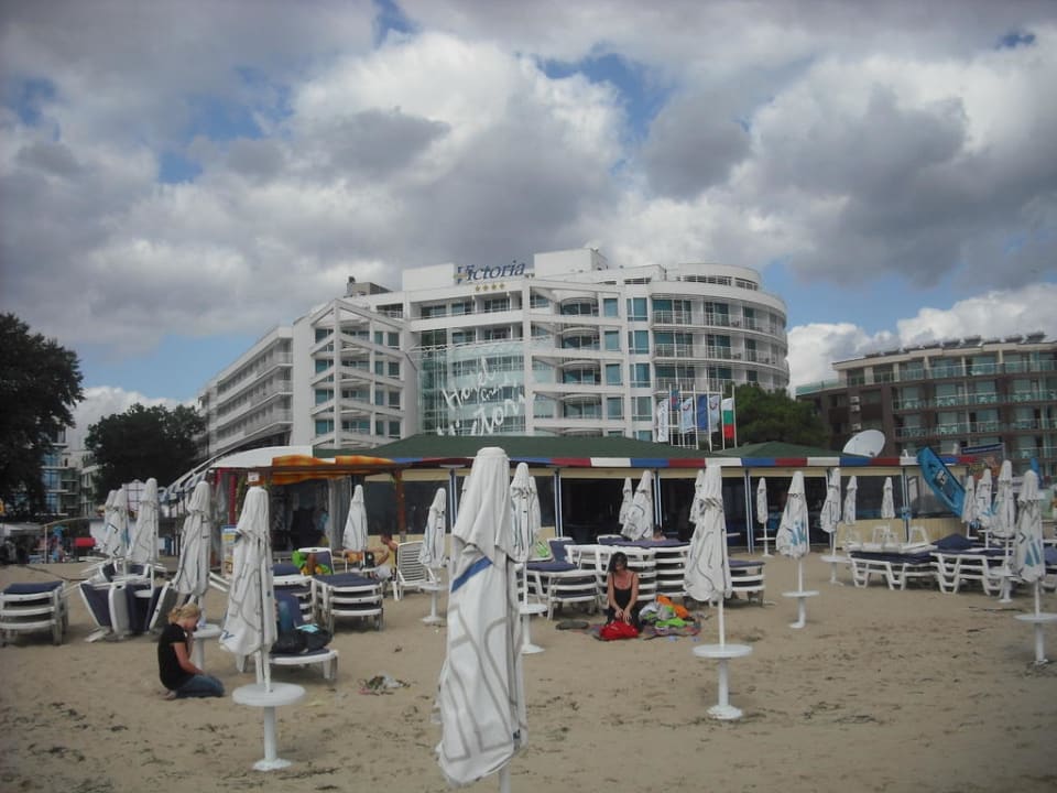 The hotel from the beach Effect Grand Victoria Hotel