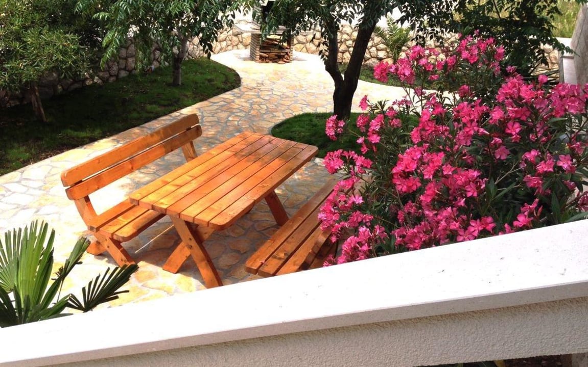 Wooden table in the courtyard with bbq Apartments Vrtlići