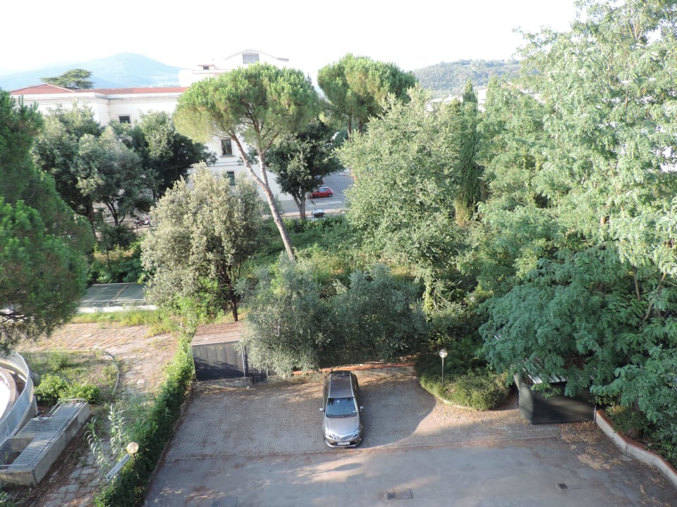 Zadní parkoviště u hotelu s odstavenou čistírnou Hotel Corolle