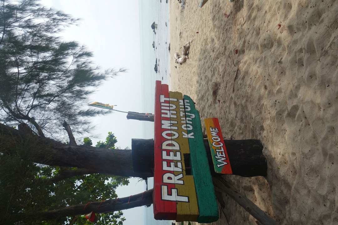 Hotel sign on the beach Freedom Hut Resort