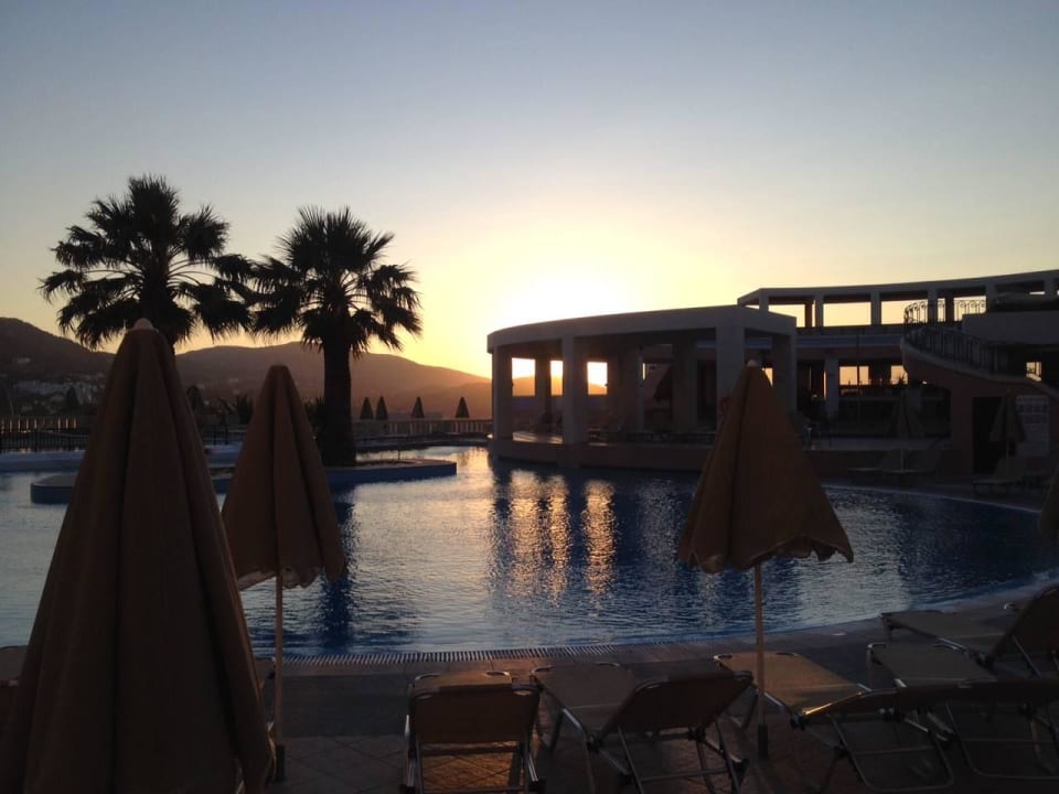 Animation pool in the evening Athina Palace Resort & Spa