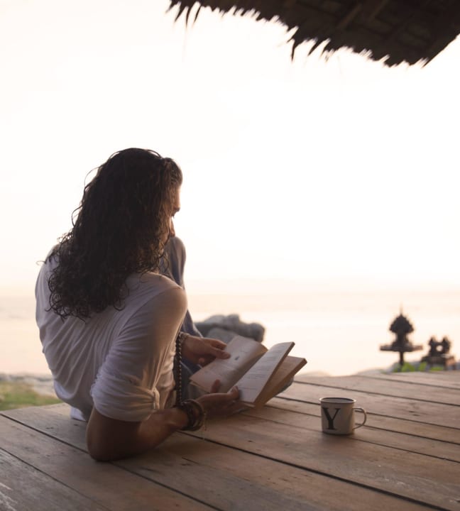 Chilling with a book in front of the beach Somewhere Only We Know Resort