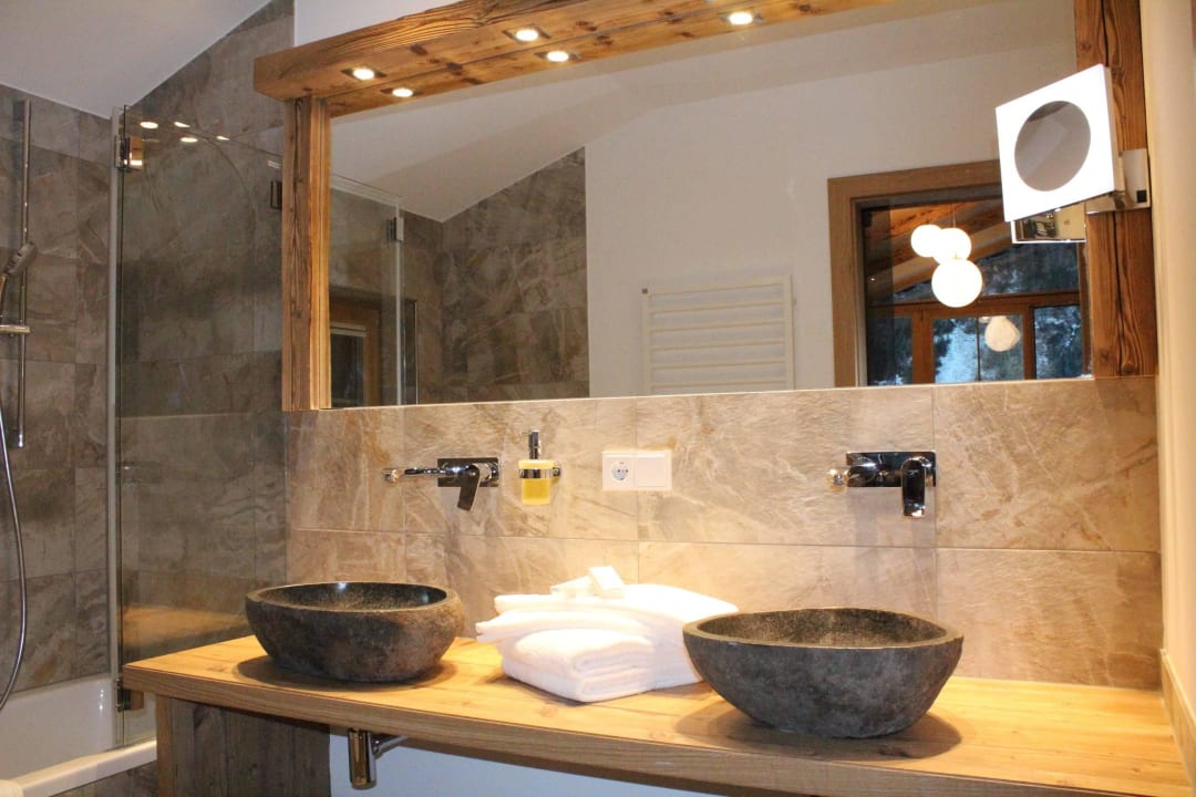 Badezimmer mit großem Spiegel Oberlechtaler Hof