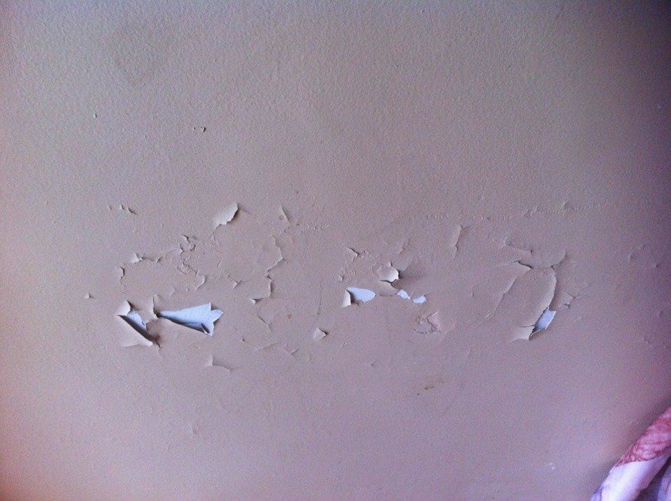 Peeling paint throughout room Motel & Cottages Beachfront at Wasaga