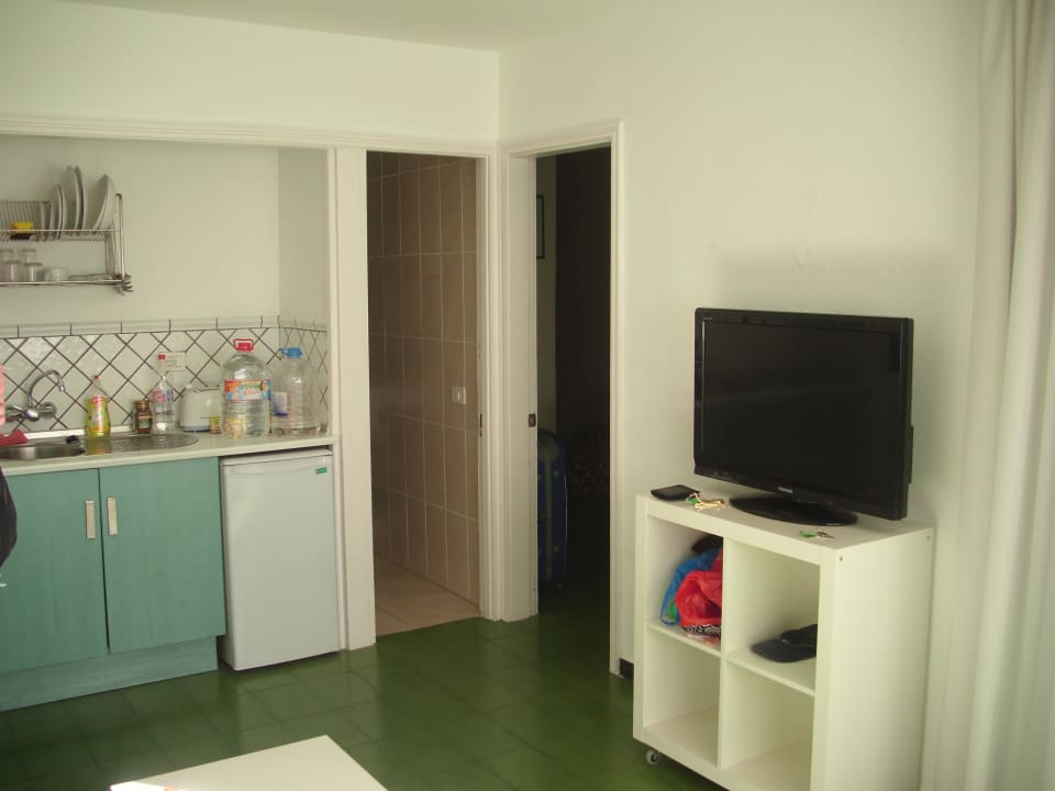 TV und kleine Küchenzeile.  Sunny Village