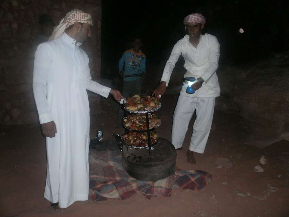 Your hosts cook a traditional Bedouin dinner Wadi Rum Travel Camp