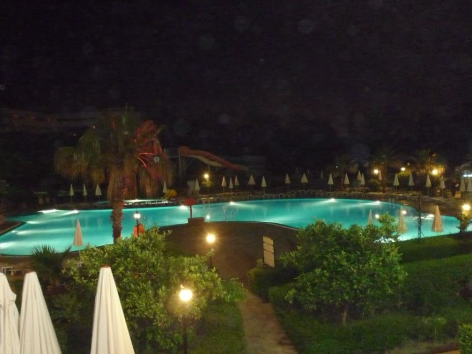 Pool by night Bella Resort & Spa