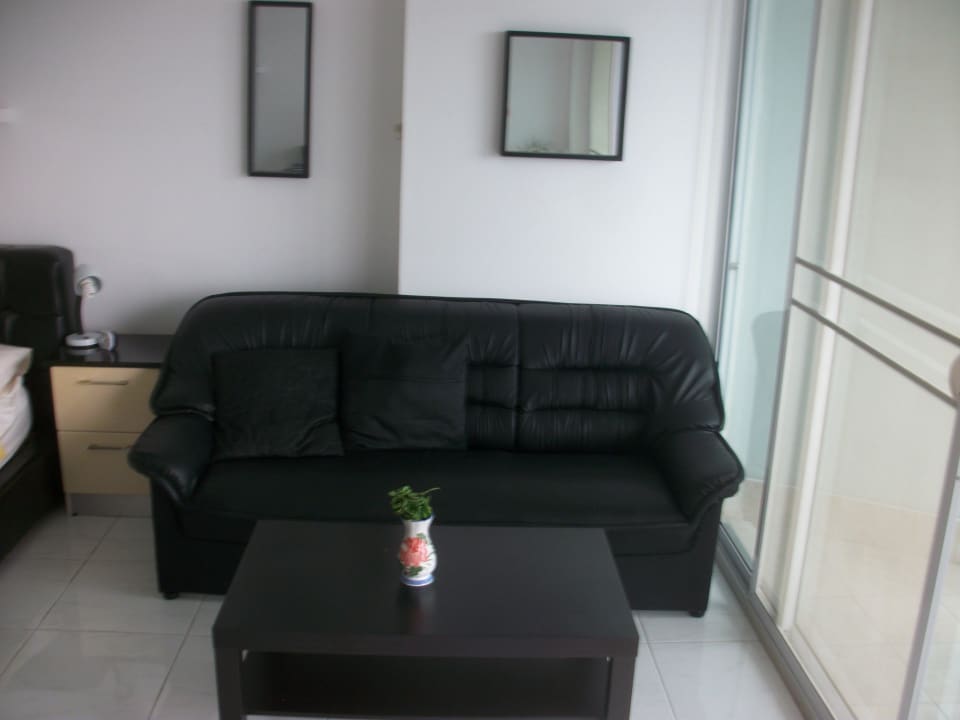 Sesselgruppe mit Tür zum Balkon Hotel Vtsix Condo Service at View Talay Condo Pattaya