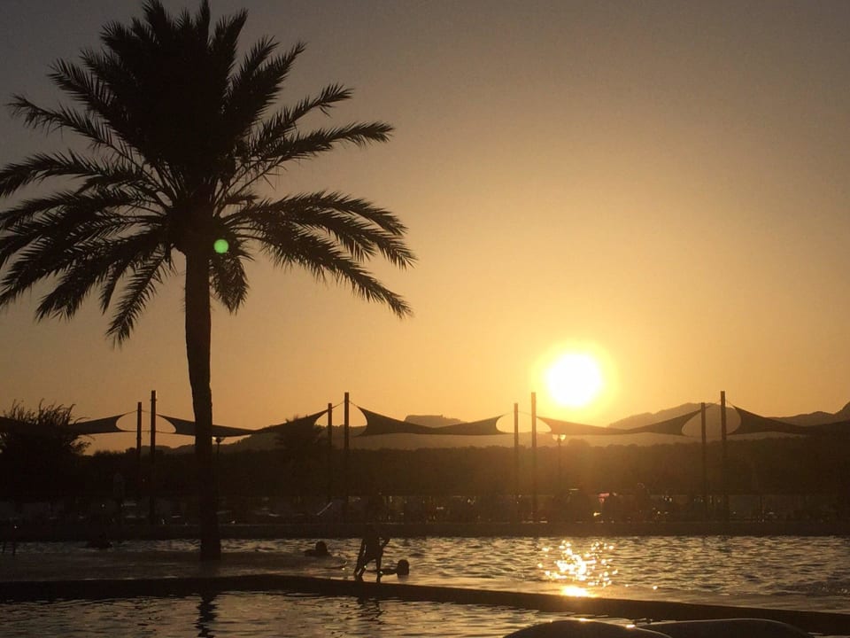 Sunset over pool Hotel Club Cala Romani