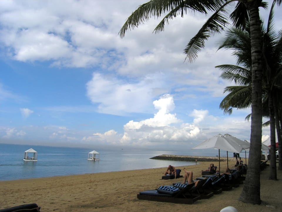 Strand mit Pavillons im Meer Puri Santrian